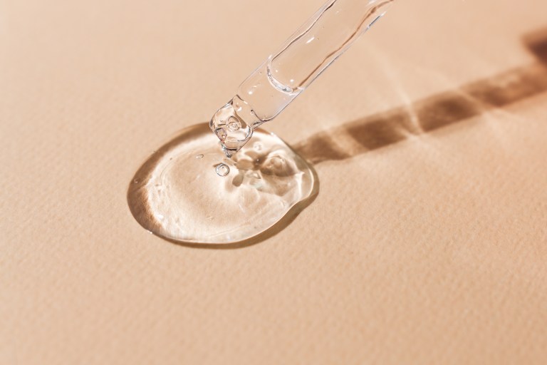 skincare dropper with hyaluronic acid on a surface